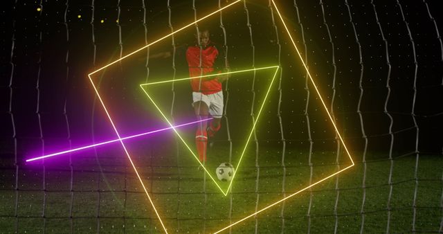 Soccer player captured mid-action as they kick the ball towards the goal, enhanced with dynamic neon light effects creating triangles and lines. Suitable for use in advertisements, sports promotions, modern and futuristic sports designs, and entertainment visuals related to football or athletic performances.
