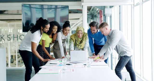 Diverse Team Collaborating in Modern Office with Laptop Indicating Teamwork and Innovation - Download Free Stock Images Pikwizard.com