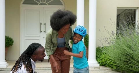 Family Moments: Teaching Kid to Ride Bike in Front of House