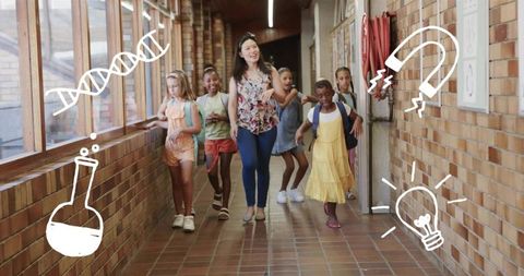 Elementary teacher leading students down sunlit brick school corridor with backpacks