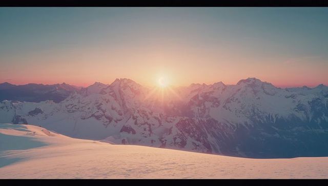 Alpine Sunrise Over Snow-Covered Mountain Ridge
