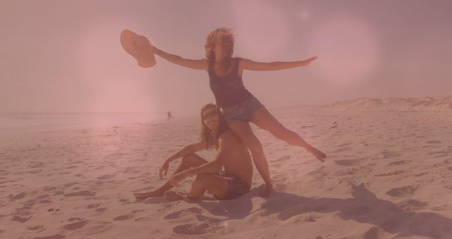 Couple Enjoying Playful Moment on Sunny Beach - Download Free Stock Images Pikwizard.com