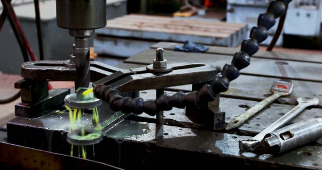 A drill press operates in an industrial setting - Download Free Stock Photos Pikwizard.com