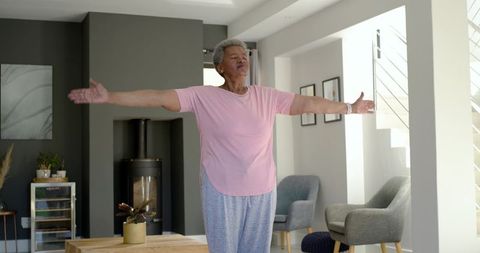 Senior woman stretching in modern living room promoting wellness and good posture