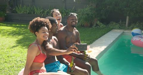 Group of Friends Taking Selfie by Poolside on Sunny Day