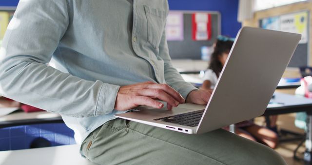 Teacher Using Laptop in Classroom Preparing Lesson Plans - Download Free Stock Images Pikwizard.com