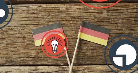 Digital media icons overlaying german flags on wooden surface