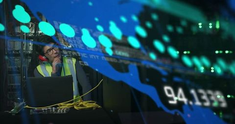 Technician monitoring server data in high-tech environment