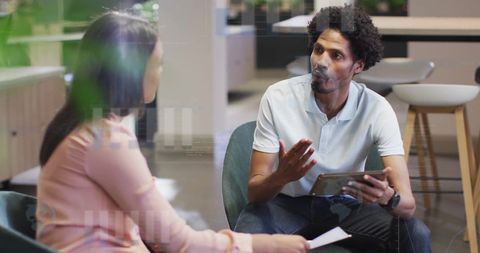 Colleagues Discussing Financial Strategies in Modern Office