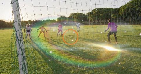 Goalkeeper Diving With Rainbow Lens Flare During Intense Soccer Match