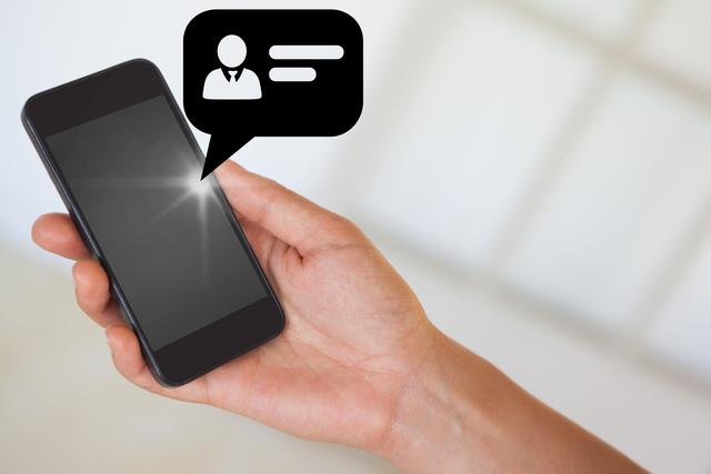 Hand holding smartphone with notification icon showing person and chat. Useful for illustrating modern communication, technology use, mobile applications, online chatting, or social media engagement.