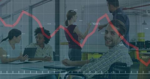 Smiling man in wheelchair collaborating with team in office with data graph overlay