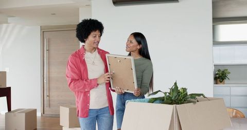 Diverse Couple Unpacking in New Home