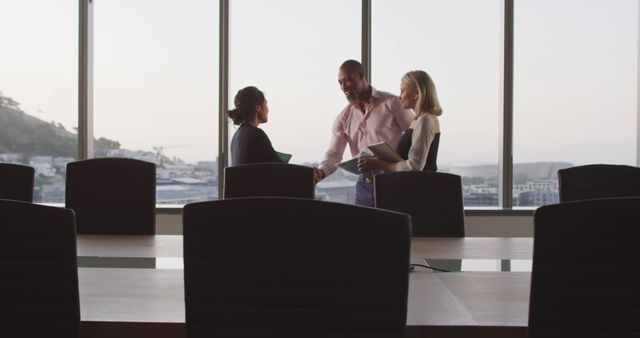 Three Business Professionals Shaking Hands in Modern Conference Room - Download Free Stock Images Pikwizard.com