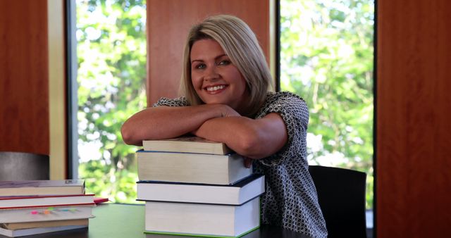 Smiling Student with Stack of Books in Library - Download Free Stock Images Pikwizard.com