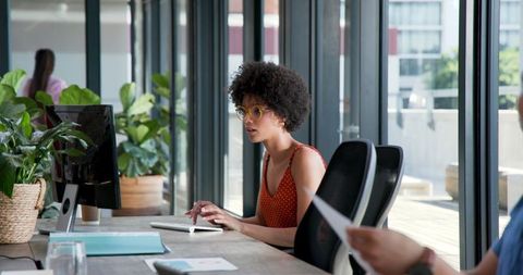 Young Female Professional Working at Modern Office Desk
