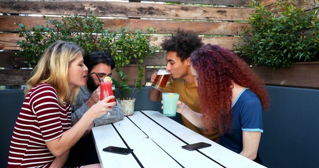 Group of Friends Enjoying Drinks at Outdoor Cafe - Download Free Stock Images Pikwizard.com