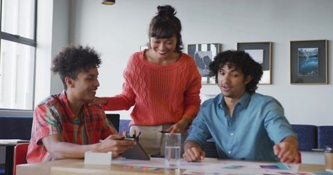 Creative team discussing design samples in modern office