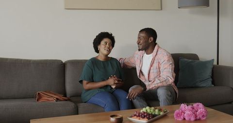 Friends Laughing and Connecting on Sofa at Home