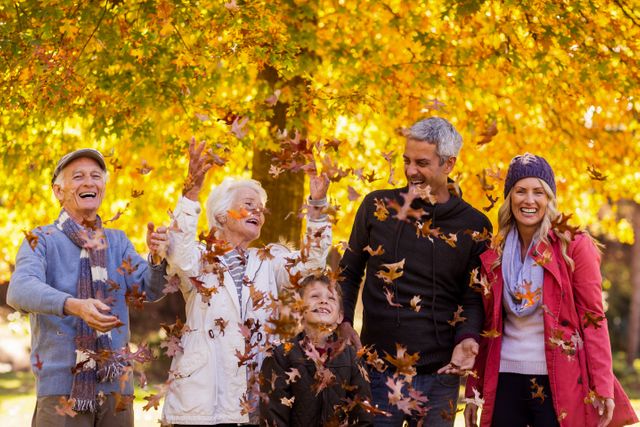 Happy multi-generation family enjoying at park during autumn