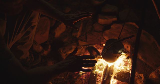 Person Warming Hands Over Campfire with Kettle - Download Free Stock Images Pikwizard.com