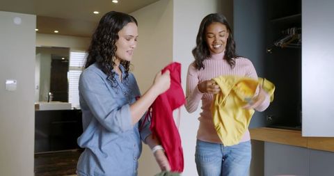 Female Friends Choosing Outfits in Bright Modern Dressing Area