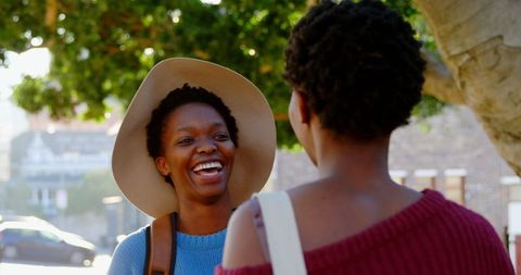 Joyful Sisters Interacting Outdoors in Urban Setting