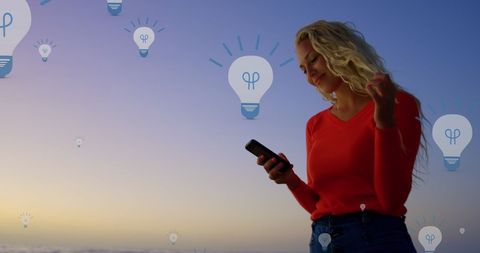 Woman interacting with technology at sunset and idea concept