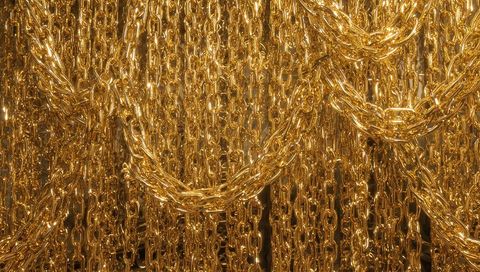 Shimmering gold chain curtain display featuring dense cable and rope chain links