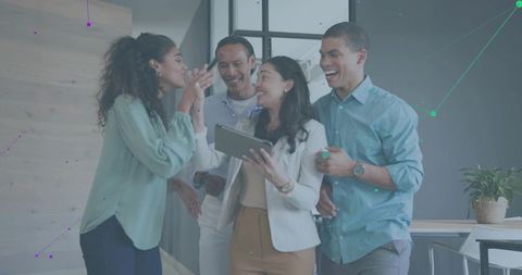 Diverse team collaborating around tablet with data overlay for office presentation planning