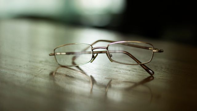 Close-up of Eyeglasses on Wooden Surface in Soft Focus Background - Download Free Stock Photos Pikwizard.com