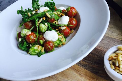 Cherry Tomato and Creamy Mozzarella Salad Tossing in Basil Pesto with Arugula and Pine Nuts