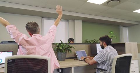 Diverse coworkers improving ergonomics in open plan office