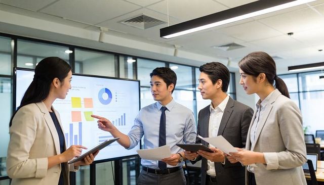 Presenting analytics and discussing strategy in modern office meeting with dashboards