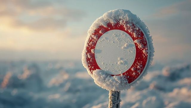Snow-Covered Circular Traffic Sign in Serene Winter Sunrise