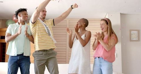 Joyful Friends Celebrating at Home with Confetti