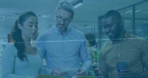 Team reviewing documents with digital data overlay in modern corporate workspace