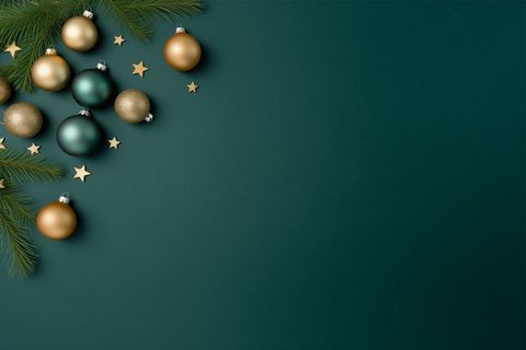 Christmas Baubles and Pine Branch on Green Background