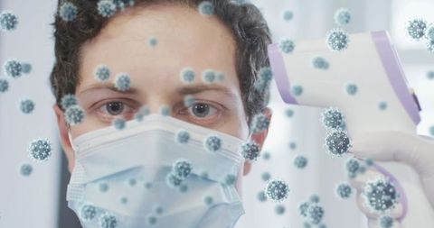 Healthcare worker checking temperature amidst virus cells