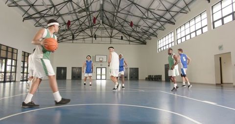 Basketball Game with Diverse Team in Indoor Gym