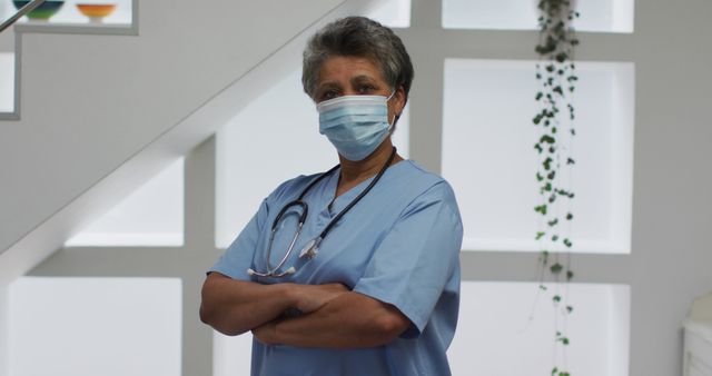 Senior Nurse Wearing Mask with Arms Crossed in Hospital - Download Free Stock Images Pikwizard.com