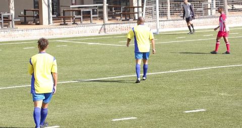 Youth Soccer Players Engaged in Competitive Game on Field