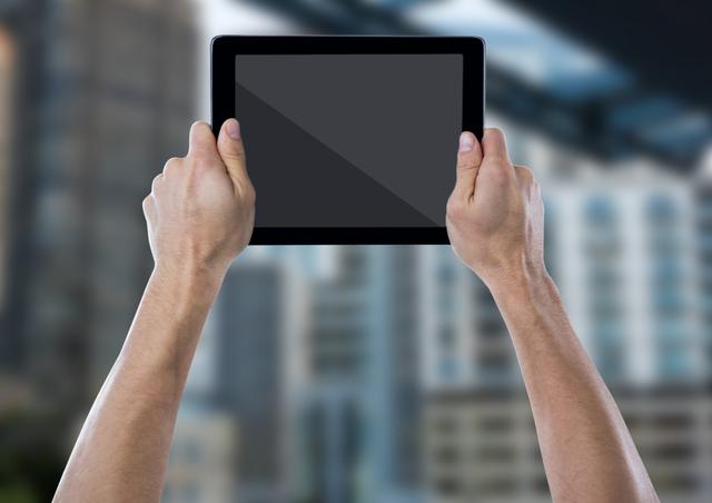Digital composite of Hand with tablet against blurry building
