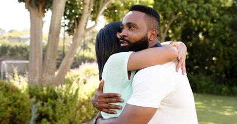 Interracial Couple Embracing in Peaceful Backyard Garden