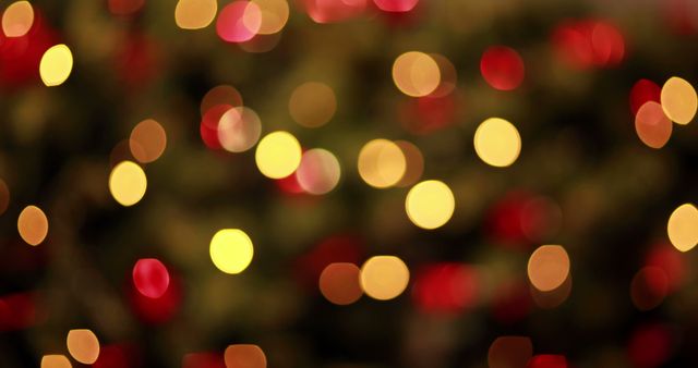 Blurry bokeh lights in red and yellow creating a festive holiday atmosphere. Useful for Christmas and holiday-themed designs, greeting cards, posters, and social media posts. Perfect as a background for invitations and marketing materials during the holiday season.