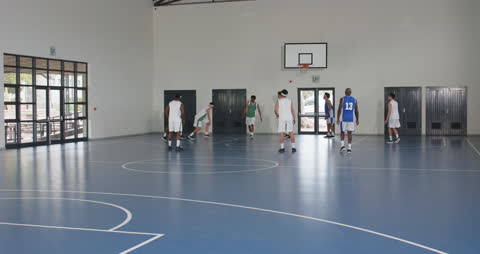 Basketball Team Practicing Indoors Focusing on Teamwork
