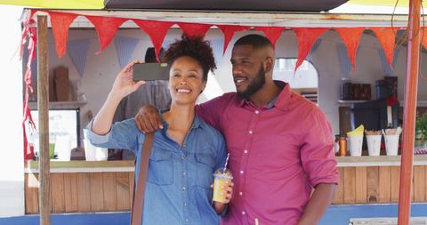 Smiling Couple Taking Selfie at Vibrant Food Truck - Download Free Stock Images Pikwizard.com