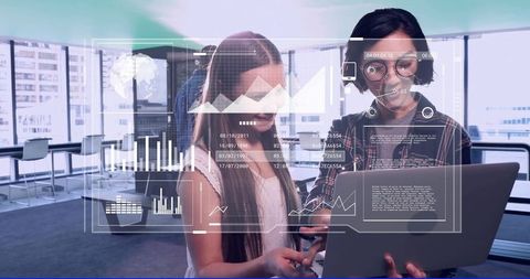 Young coworkers collaborating on laptop with holographic analytics dashboards in city office