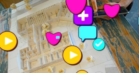 Architectural model presenting with social reaction icons and tattooed hands using tablet