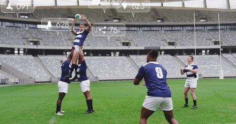 Rugby lineout lifting catching ball on stadium pitch with teammates and goalposts